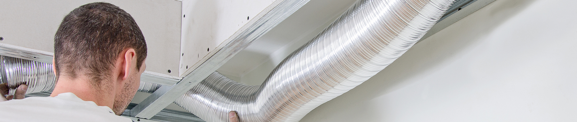 image of a man working with an air duct